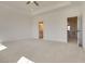 Spacious primary bedroom featuring a tray ceiling, neutral carpet, and ensuite bathroom access at 3118 Vanessa Lynne Blvd, Johns Island, SC 29455