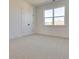 Bright bedroom with large window and natural light, featuring neutral carpet and white trim at 3118 Vanessa Lynne Blvd, Johns Island, SC 29455