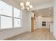Bright dining area showcasing modern chandelier, hardwood floors, and seamless open-concept layout to kitchen at 3118 Vanessa Lynne Blvd, Johns Island, SC 29455