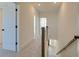 Bright hallway features neutral carpeting, multiple rooms, and a wooden railing overlooking the floor below at 3118 Vanessa Lynne Blvd, Johns Island, SC 29455