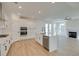 Well-lit kitchen featuring white cabinets, stainless steel appliances, center island, and seamless access to living room at 3118 Vanessa Lynne Blvd, Johns Island, SC 29455