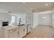 Modern kitchen with a center island with sink and stainless steel dishwasher open to living and dining areas at 3118 Vanessa Lynne Blvd, Johns Island, SC 29455