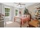 Charming bedroom with large windows, cozy bedding, and a serene atmosphere at 32 Middleton Oaks Rd, Charleston, SC 29414