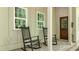 Inviting front porch with rocking chairs and views of the landscaped yard; perfect for relaxing outdoors at 32 Middleton Oaks Rd, Charleston, SC 29414