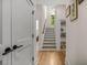 Bright hallway with hardwood floors, staircase, and built-in bookcase at 32 Middleton Oaks Rd, Charleston, SC 29414