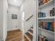 Hallway features a staircase with hardwood floors and a built-in bookcase at 32 Middleton Oaks Rd, Charleston, SC 29414