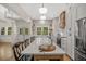 Bright kitchen with a large island, stainless appliances, white cabinets and a brick backsplash around the sink at 32 Middleton Oaks Rd, Charleston, SC 29414