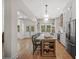 Bright kitchen with a large island, stainless appliances, white cabinets, hardwood floors, and pendant lights at 32 Middleton Oaks Rd, Charleston, SC 29414