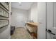 Functional laundry room with wood counters, storage baskets, and brick-patterned tile flooring at 32 Middleton Oaks Rd, Charleston, SC 29414