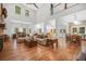 Open concept living room with high ceilings, fireplace, hardwood floors, and seamless flow to the kitchen at 32 Middleton Oaks Rd, Charleston, SC 29414