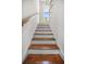 Bright stairway with hardwood steps and white risers leading to upper level at 32 Middleton Oaks Rd, Charleston, SC 29414