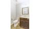 Bathroom with a dark vanity cabinet, white countertop, toilet and framed mirror at 321 Houston Dr, Ladson, SC 29456