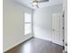 Bedroom with dark hardwood floors, a ceiling fan, white trim, a window, and a door at 321 Houston Dr, Ladson, SC 29456