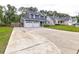 Long driveway to a charming two-story home with an attached two-car garage at 321 Houston Dr, Ladson, SC 29456