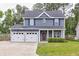 Charming two-story home with an attached two-car garage and a well-manicured front lawn at 321 Houston Dr, Ladson, SC 29456