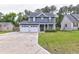 Charming two-story home with an attached two-car garage and a well-manicured front lawn at 321 Houston Dr, Ladson, SC 29456