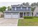 Charming two-story home with an attached two-car garage and a well-manicured front lawn at 321 Houston Dr, Ladson, SC 29456