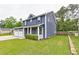 View of the house corner showing the 2 car garage and covered porch at 321 Houston Dr, Ladson, SC 29456