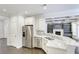 Bright kitchen features stainless steel appliances, island with seating, and a view into the living room with a fireplace at 321 Houston Dr, Ladson, SC 29456