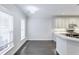 Bright kitchen featuring white cabinetry, countertops and clear view to the eating area with window and natural light at 321 Houston Dr, Ladson, SC 29456