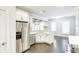 Spacious kitchen with stainless steel appliances, island with sink, and view of the living room and fireplace at 321 Houston Dr, Ladson, SC 29456