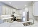 Bright kitchen featuring stainless steel appliances, white cabinets, tile backsplash and countertops at 321 Houston Dr, Ladson, SC 29456