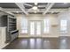 Living room featuring coffered ceiling, ceiling fan, a fireplace, built-in shelving, and door to back porch at 321 Houston Dr, Ladson, SC 29456