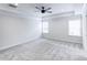 Large carpeted main bedroom featuring a tray ceiling, fan, and natural light at 321 Houston Dr, Ladson, SC 29456