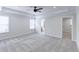 Spacious main bedroom with tray ceiling, ceiling fan, and plush neutral carpeting at 321 Houston Dr, Ladson, SC 29456