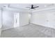 Bright, carpeted main bedroom featuring tray ceiling, ceiling fan, and ensuite bath at 321 Houston Dr, Ladson, SC 29456