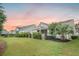 Beautifully landscaped backyard featuring a well-manicured lawn, lush plantings, and an inviting outdoor living space at 331 Fish Creek Ct, Summerville, SC 29486