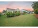 Spacious backyard with lush green lawn, mature landscaping, and a screened-in patio at 331 Fish Creek Ct, Summerville, SC 29486