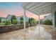 A backyard travertine patio with a white pergola, and a brick retaining wall at 331 Fish Creek Ct, Summerville, SC 29486