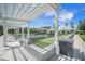 Inviting bocce ball court under pergola featuring meticulously maintained green turf and convenient seating areas at 331 Fish Creek Ct, Summerville, SC 29486