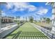 Scenic bocce ball court with lush artificial turf, nestled beside a tranquil pond and community amenities at 331 Fish Creek Ct, Summerville, SC 29486
