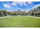 Beautiful clubhouse featuring a manicured lawn area, palm trees, and comfortable outdoor seating at 331 Fish Creek Ct, Summerville, SC 29486