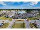 Stunning aerial view of a community center complex featuring a lake, pristine landscaping and ample parking at 331 Fish Creek Ct, Summerville, SC 29486
