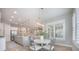 Open concept dining area with a view to the kitchen and living room has a modern light fixture at 331 Fish Creek Ct, Summerville, SC 29486