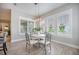 Bright dining area features wood floors, a modern chandelier, and three shuttered windows at 331 Fish Creek Ct, Summerville, SC 29486