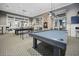 Another view of the game room with stylish pool tables, pendant lighting, and exposed brick accents at 331 Fish Creek Ct, Summerville, SC 29486