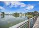 Picturesque lake view from the wooden boardwalk, surrounded by trees and homes at 331 Fish Creek Ct, Summerville, SC 29486