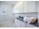 Well-lit laundry room with ample storage cabinets and a dark countertop at 331 Fish Creek Ct, Summerville, SC 29486