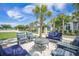 Stylish outdoor seating area with comfortable seating, a small table, palm trees and a view of the lake at 331 Fish Creek Ct, Summerville, SC 29486