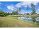 A serene pond is showcased with lush greenery, providing a peaceful backdrop for community residences at 331 Fish Creek Ct, Summerville, SC 29486