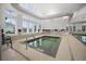 Bright indoor spa with tile accents, natural light, and visible pool area at 331 Fish Creek Ct, Summerville, SC 29486