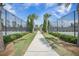 Scenic walkway leading to tennis courts, framed by manicured greenery and providing an active lifestyle at 331 Fish Creek Ct, Summerville, SC 29486