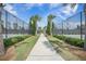 Landscaped walking path through a community leading to the tennis courts and other amenities at 331 Fish Creek Ct, Summerville, SC 29486