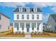 Charming two-story home featuring a welcoming front porch with classic white columns and a well-maintained yard at 365 Trailmore Ln, Summerville, SC 29486