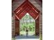 Personal biking through a park trail with red arbor roof and beautiful trees at 365 Trailmore Ln, Summerville, SC 29486