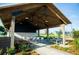 Covered outdoor patio with picnic tables, seating, and beautiful landscaping at 365 Trailmore Ln, Summerville, SC 29486